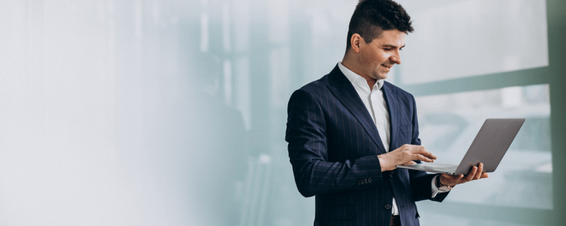 young-handsome-business-man-with-laptop-in-office